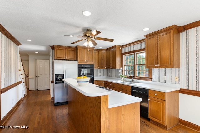 116 Spencer Ln, Newport, NC 28570 - kitchen with black appliances, wallpapered walls, dark wood-style floors, light countertops, and a kitchen island