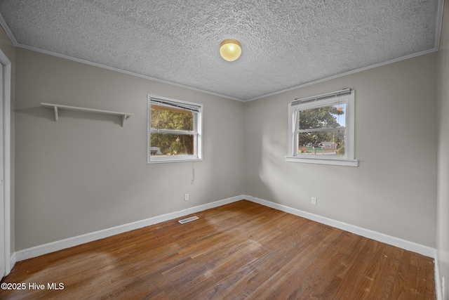 2411 Grace Ave, New Bern, NC 28562 - spare room with wood finished floors, crown molding, a textured ceiling, and baseboards