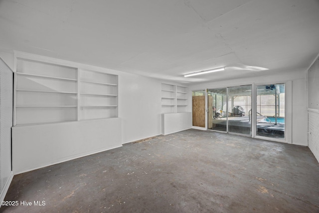 2411 Grace Ave, New Bern, NC 28562 - spare room featuring unfinished concrete floors and built in shelves