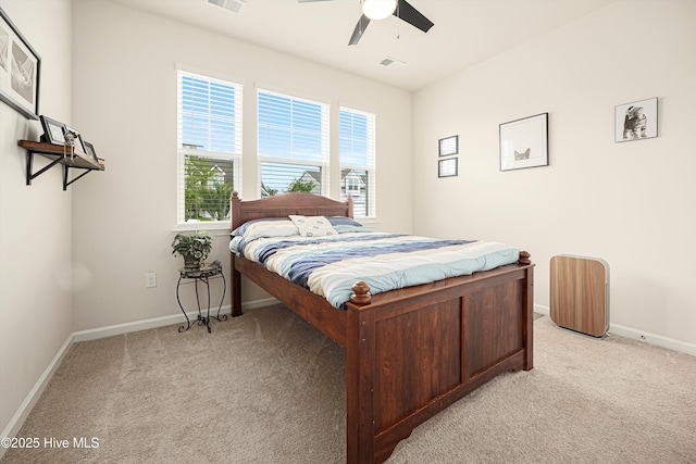 2106 Cass Lake Rd, Calabash, NC 28467 - bedroom featuring light carpet, multiple windows, baseboards, and a ceiling fan