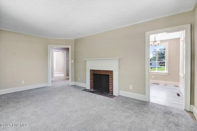 403 S Andrews Ave, Goldsboro, NC 27530 - unfurnished living room featuring a chandelier, carpet, a textured ceiling, a fireplace, and baseboards