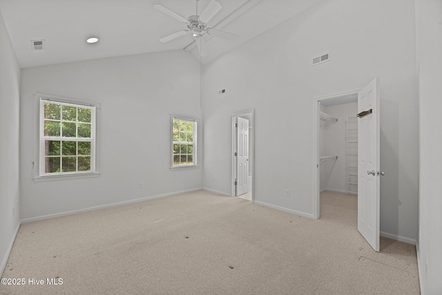 309 Belle Oaks Dr, New Bern, NC 28562 - unfurnished bedroom featuring light colored carpet, a spacious closet, multiple windows, baseboards, and high vaulted ceiling