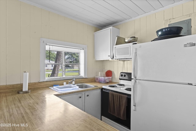 307 Preston Rd Unit A & B, Jacksonville, NC 28540 - kitchen featuring white appliances, a sink, light countertops, crown molding, and wood finished floors