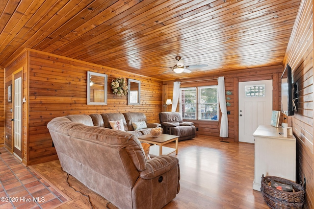 103 NE 17th St, Oak Island, NC 28465 - living area featuring wood ceiling, wooden walls, and a ceiling fan