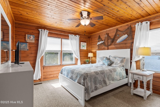 103 NE 17th St, Oak Island, NC 28465 - bedroom featuring wooden ceiling, carpet floors, and wooden walls
