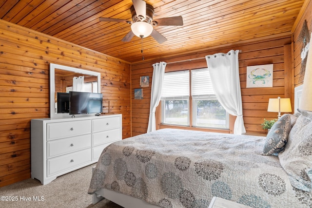 103 NE 17th St, Oak Island, NC 28465 - bedroom featuring wood ceiling, multiple windows, carpet floors, wooden walls, and ceiling fan