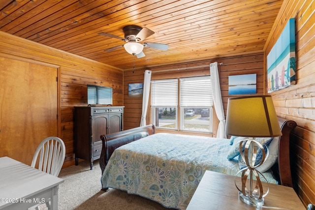 103 NE 17th St, Oak Island, NC 28465 - carpeted bedroom with wooden walls, wood ceiling, and ceiling fan