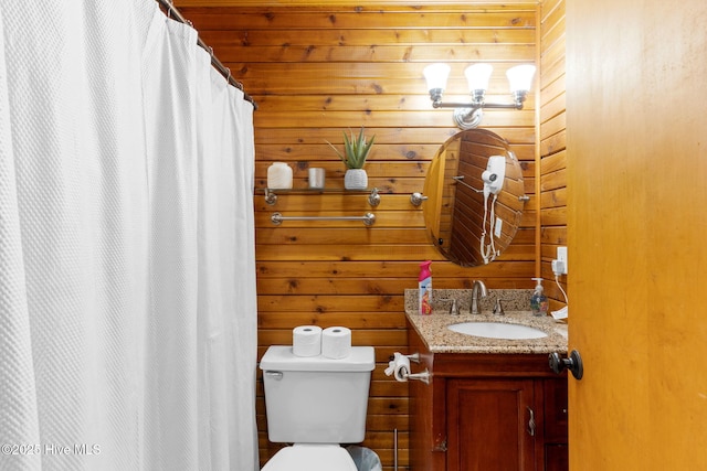 103 NE 17th St, Oak Island, NC 28465 - bathroom featuring vanity, toilet, wooden walls, and a shower with curtain