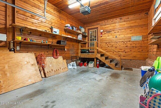 103 NE 17th St, Oak Island, NC 28465 - garage with wood walls, a garage door opener, and wooden ceiling
