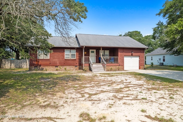 103 NE 17th St, Oak Island, NC 28465 - view of front of house featuring crawl space, a porch, driveway, roof with shingles, and an attached garage