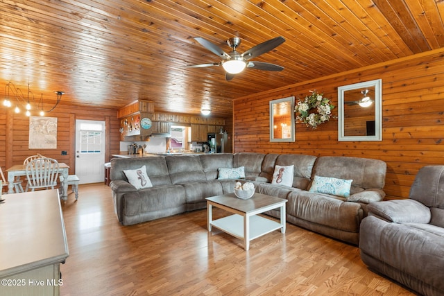 103 NE 17th St, Oak Island, NC 28465 - living area with wooden ceiling, a ceiling fan, light wood-style floors, and wood walls