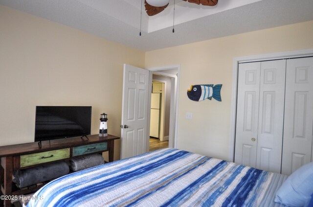 505 Sunset Oaks Ln, Sunset Beach, NC 28468 - bedroom with freestanding refrigerator, a closet, and ceiling fan