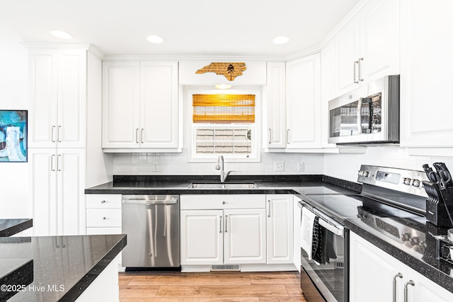 271 E Second St, Ocean Isle Beach, NC 28469 - kitchen featuring stainless steel appliances, a sink, white cabinetry, and recessed lighting