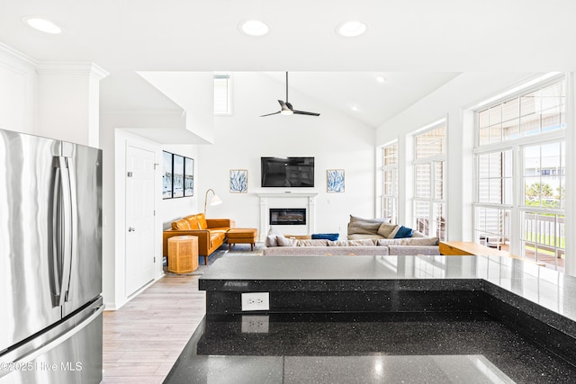 271 E Second St, Ocean Isle Beach, NC 28469 - kitchen featuring freestanding refrigerator, plenty of natural light, a glass covered fireplace, recessed lighting, and ceiling fan