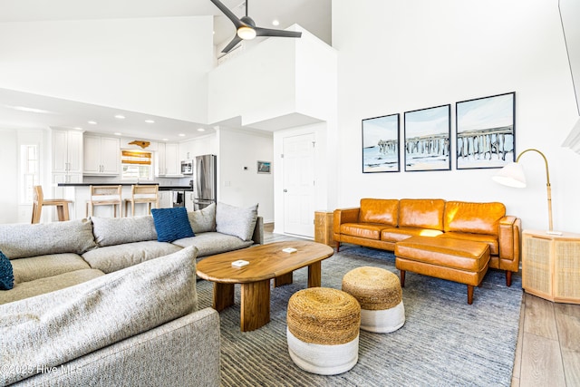 271 E Second St, Ocean Isle Beach, NC 28469 - living room with light wood finished floors, a high ceiling, ceiling fan, and recessed lighting