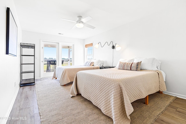271 E Second St, Ocean Isle Beach, NC 28469 - bedroom with access to outside, baseboards, light wood-style flooring, and a ceiling fan