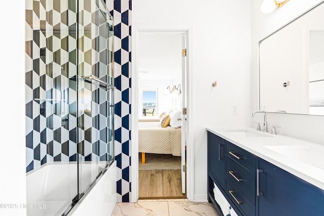 271 E Second St, Ocean Isle Beach, NC 28469 - ensuite bathroom featuring marble look tiles, double vanity,  shower combination, and baseboards