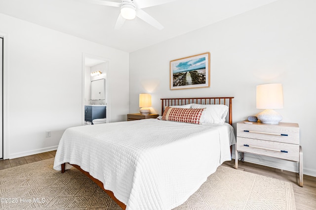 271 E Second St, Ocean Isle Beach, NC 28469 - bedroom with wood finished floors, baseboards, connected bathroom, and ceiling fan