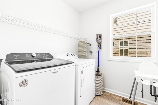271 E Second St, Ocean Isle Beach, NC 28469 - laundry area featuring washing machine and clothes dryer, light wood-style flooring, and baseboards