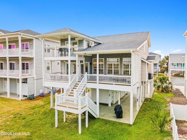271 E Second St, Ocean Isle Beach, NC 28469 - rear view of property featuring a lawn and roof with shingles