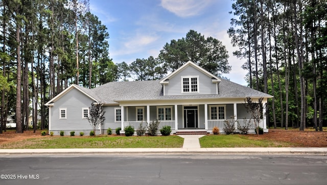 9265 W Lake Rd, Calabash, NC 28467 - view of front of house with covered porch, a shingled roof, and a front yard