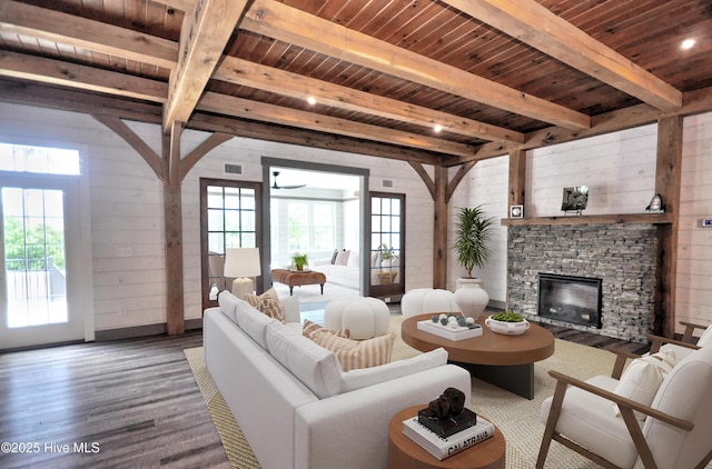 9265 W Lake Rd, Calabash, NC 28467 - living room with wood finished floors, wooden ceiling with exposed beams, wood walls, a fireplace, and baseboards