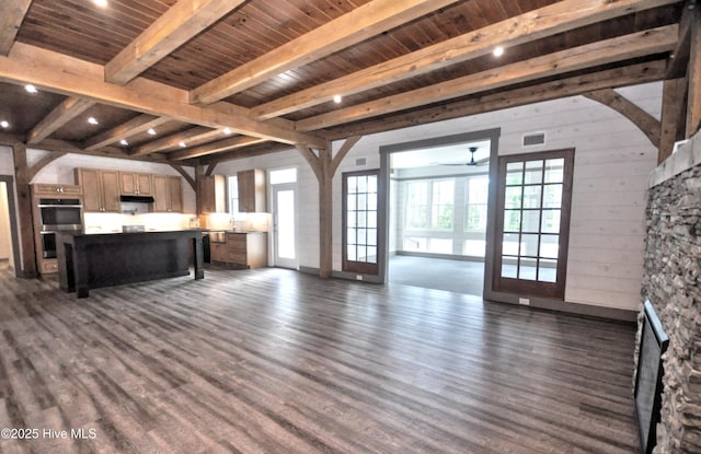9265 W Lake Rd, Calabash, NC 28467 - unfurnished living room with dark wood-style floors, ceiling fan, and wood ceiling with exposed beams