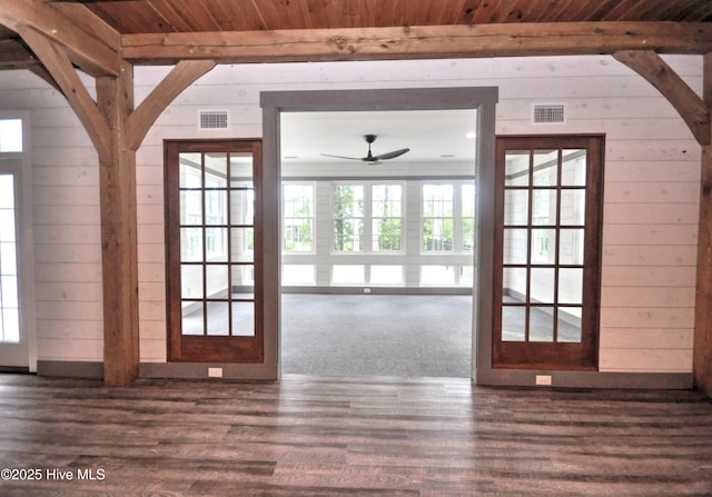 9265 W Lake Rd, Calabash, NC 28467 - doorway to outside with wood walls, ceiling fan, dark wood-style floors, wooden ceiling, and arched walkways