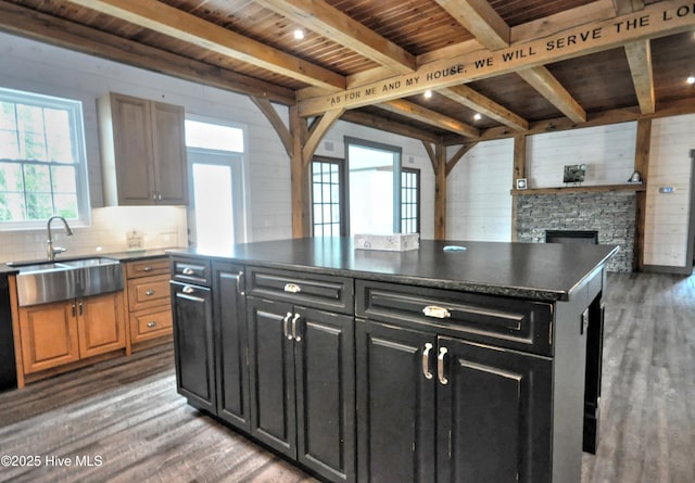 9265 W Lake Rd, Calabash, NC 28467 - kitchen featuring a sink, dark cabinets, plenty of natural light, wood finished floors, and wooden ceiling with exposed beams