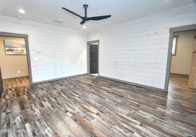 9265 W Lake Rd, Calabash, NC 28467 - unfurnished room with wood finished floors, a ceiling fan, wood walls, recessed lighting, and baseboards