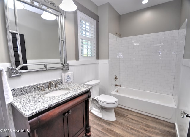 9265 W Lake Rd, Calabash, NC 28467 - bathroom with wood finished floors, toilet, vanity,  shower combination, and a wainscoted wall