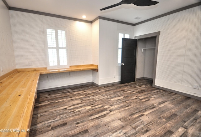 9265 W Lake Rd, Calabash, NC 28467 - unfurnished bedroom with crown molding, baseboards, dark wood finished floors, a closet, and multiple windows