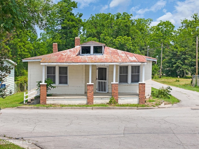 926 Cedar St, New Bern, NC 28560 - bungalow with concrete block siding, covered porch, and a chimney