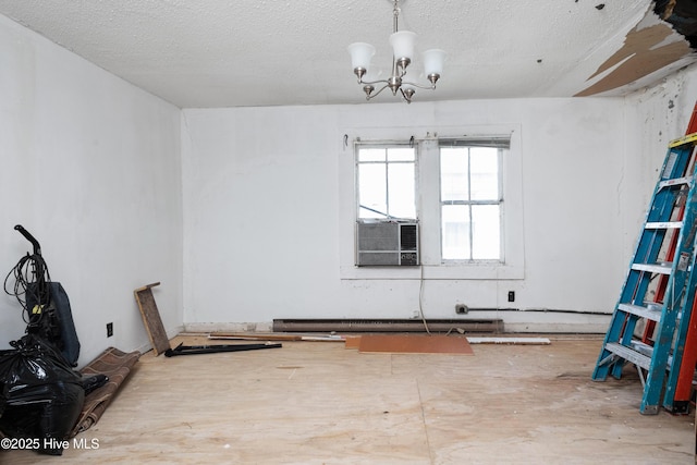 926 Cedar St, New Bern, NC 28560 - spare room featuring cooling unit, a baseboard heating unit, a chandelier, and a textured ceiling