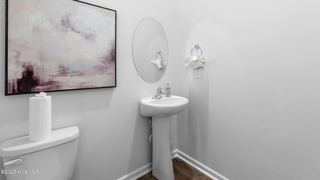2025 Minnette Cir, New Bern, NC 28562 - half bath featuring toilet, wood finished floors, a sink, and baseboards