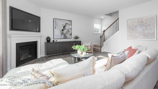 2031 Minnette Cir, New Bern, NC 28562 - living area featuring wood finished floors, stairs, baseboards, recessed lighting, and a glass covered fireplace
