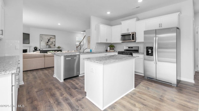 2031 Minnette Cir, New Bern, NC 28562 - kitchen with appliances with stainless steel finishes, open floor plan, backsplash, white cabinets, and recessed lighting