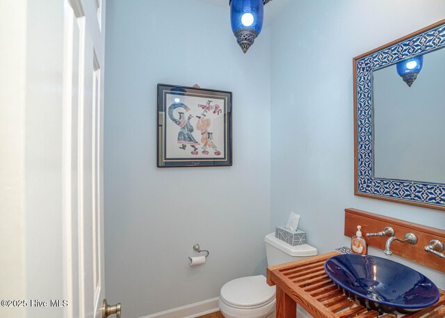 3399 Channelside Dr SW, Supply, NC 28462 - bathroom with toilet, baseboards, and vanity
