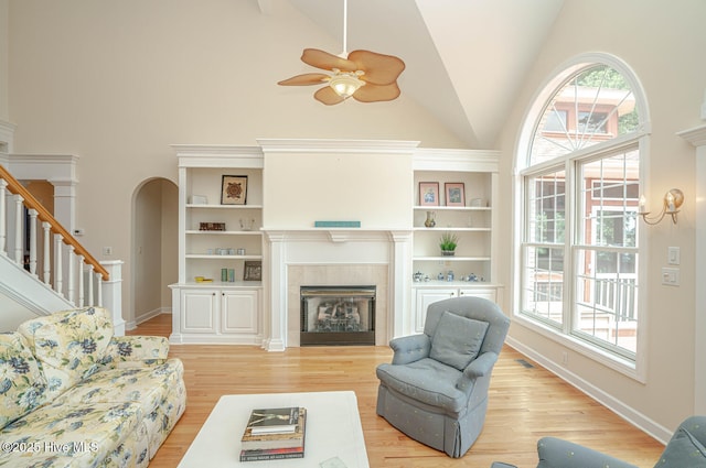 3399 Channelside Dr SW, Supply, NC 28462 - living area featuring high vaulted ceiling, ceiling fan, a fireplace, plenty of natural light, and light wood-style flooring