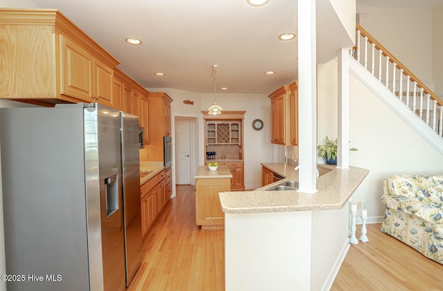 3399 Channelside Dr SW, Supply, NC 28462 - kitchen featuring stainless steel appliances, a peninsula, recessed lighting, light wood finished floors, and a sink