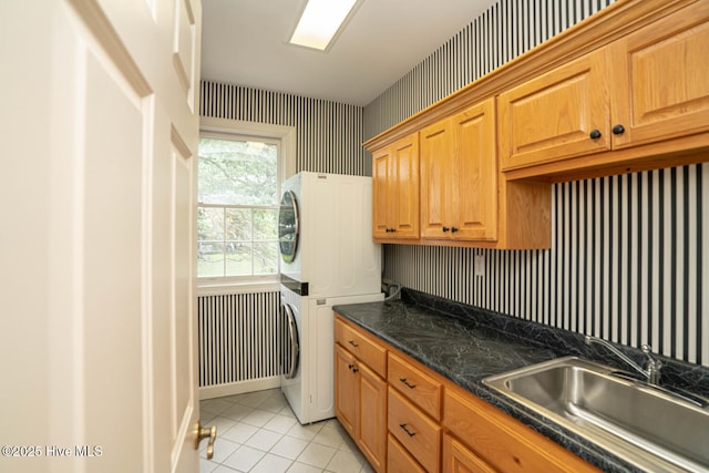 3399 Channelside Dr SW, Supply, NC 28462 - laundry room featuring stacked washer / drying machine, light tile patterned flooring, and cabinet space
