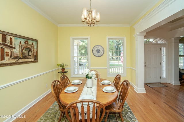 3399 Channelside Dr SW, Supply, NC 28462 - dining space with decorative columns, a chandelier, light wood-style floors, baseboards, and crown molding