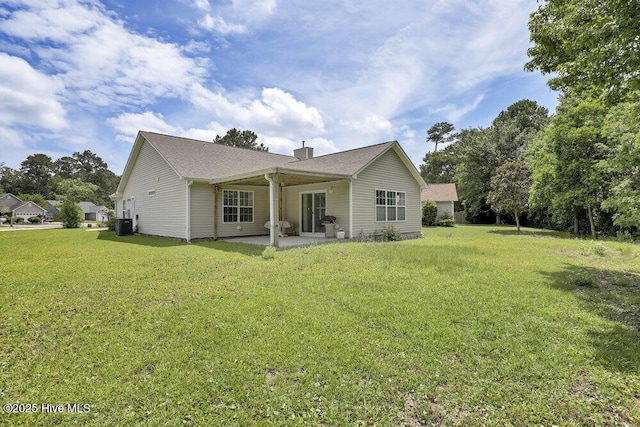 111 Bay Tree Cir, Hampstead, NC 28443 - rear view of property with a chimney, a patio, a yard, and cooling unit