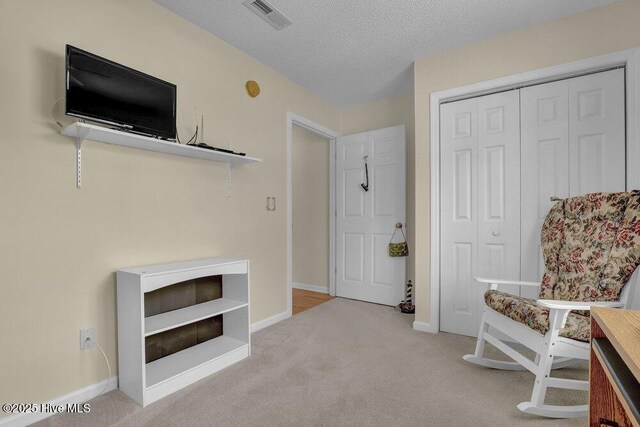 111 Bay Tree Cir, Hampstead, NC 28443 - sitting room featuring carpet floors, baseboards, and a textured ceiling