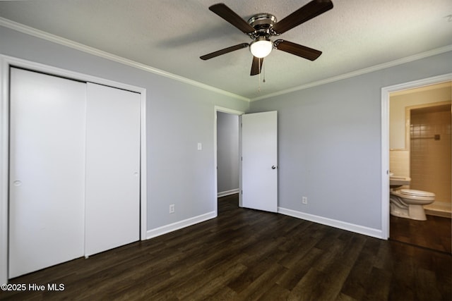 429 Swiss Rd, New Bern, NC 28560 - unfurnished bedroom with dark wood-style floors, crown molding, a closet, baseboards, and connected bathroom
