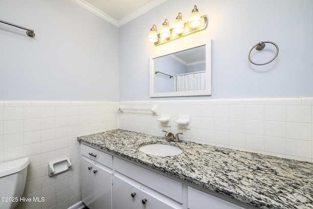 429 Swiss Rd, New Bern, NC 28560 - full bathroom with vanity, toilet, ornamental molding, tile walls, and a wainscoted wall