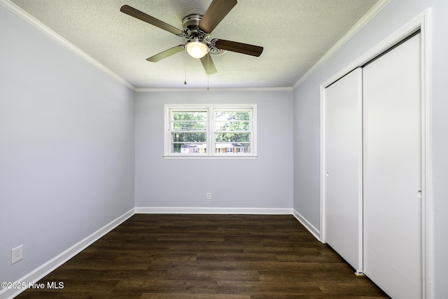 429 Swiss Rd, New Bern, NC 28560 - unfurnished bedroom with a textured ceiling, dark wood finished floors, crown molding, a closet, and baseboards