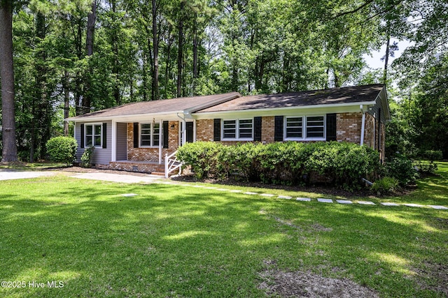 429 Swiss Rd, New Bern, NC 28560 - ranch-style house featuring a porch, a front lawn, and brick siding