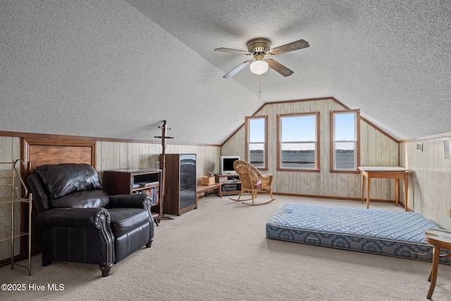 241 Moonlight Dr, Atlantic Beach, NC 28512 - bedroom featuring a textured ceiling, carpet, lofted ceiling, wood walls, and ceiling fan