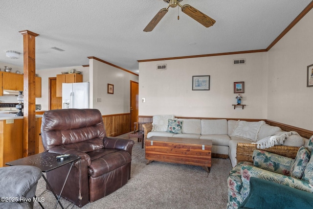 241 Moonlight Dr, Atlantic Beach, NC 28512 - living area featuring ceiling fan, wainscoting, ornamental molding, a textured ceiling, and wood walls